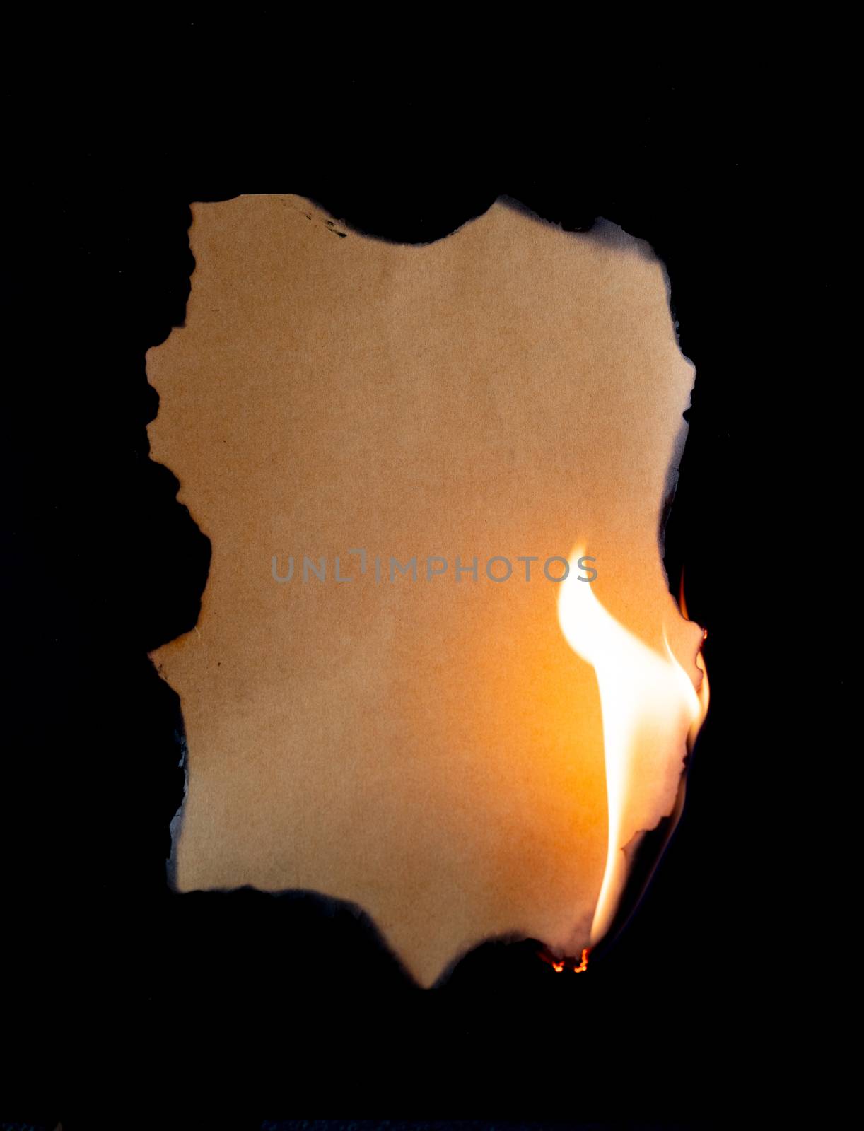 burning piece of  paper on black background