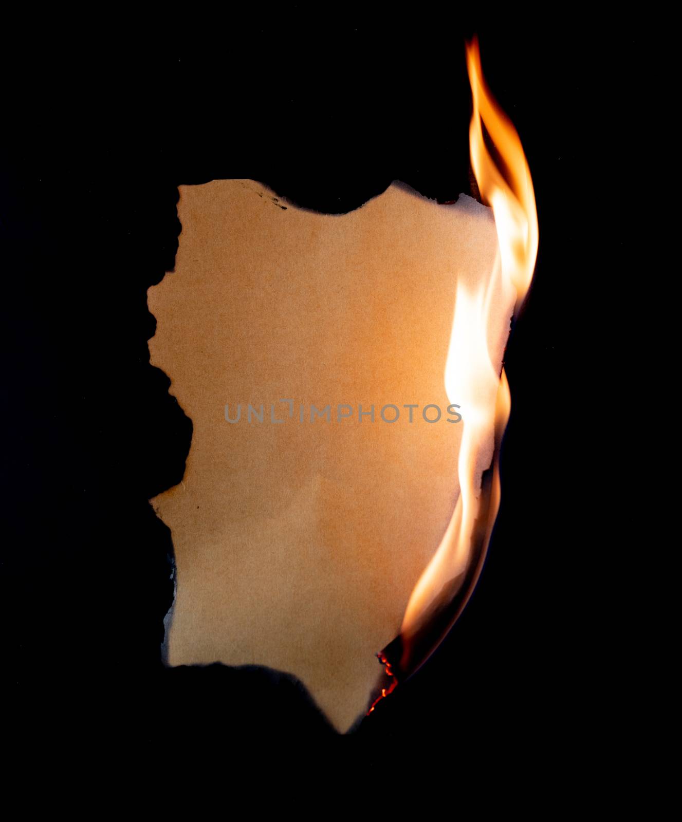 burning piece of  paper on black background