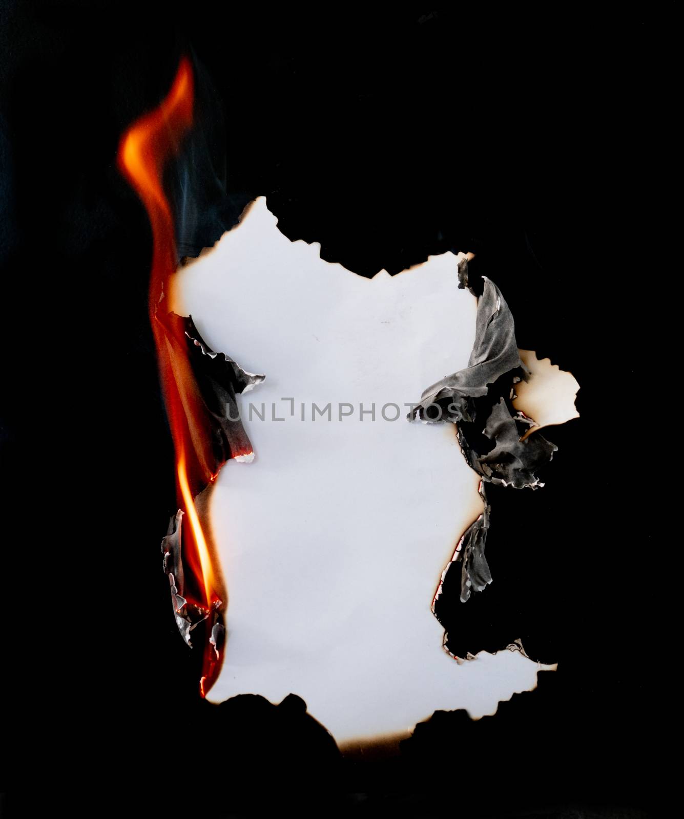 burning piece of  paper on black background