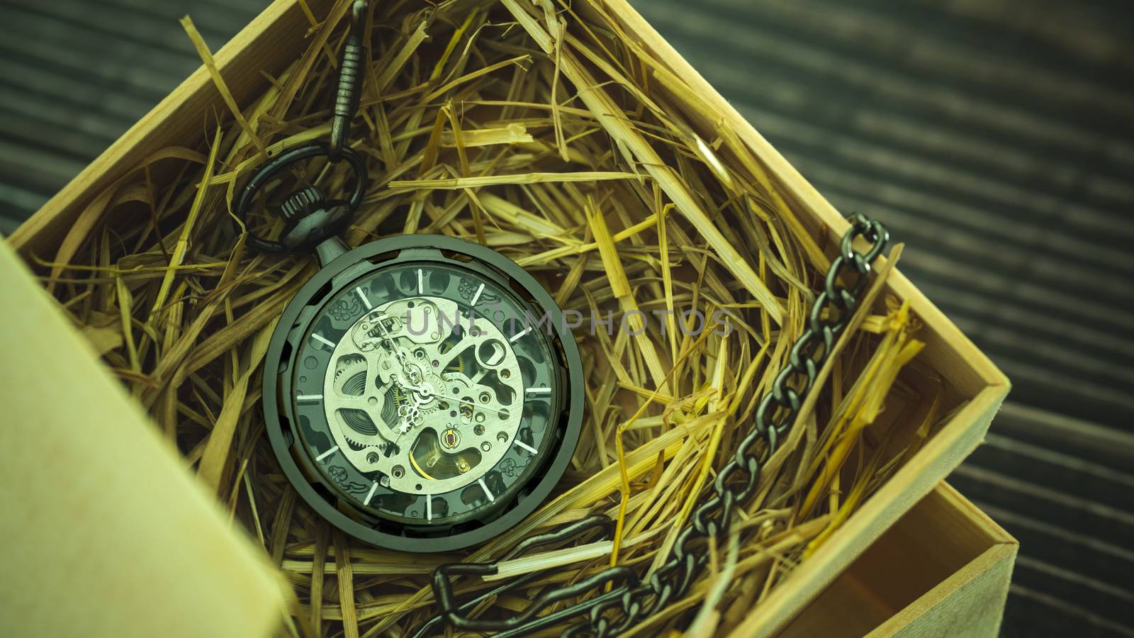 Pocket watch winder on natural wheat straw in a wooden box. Conc by SaitanSainam