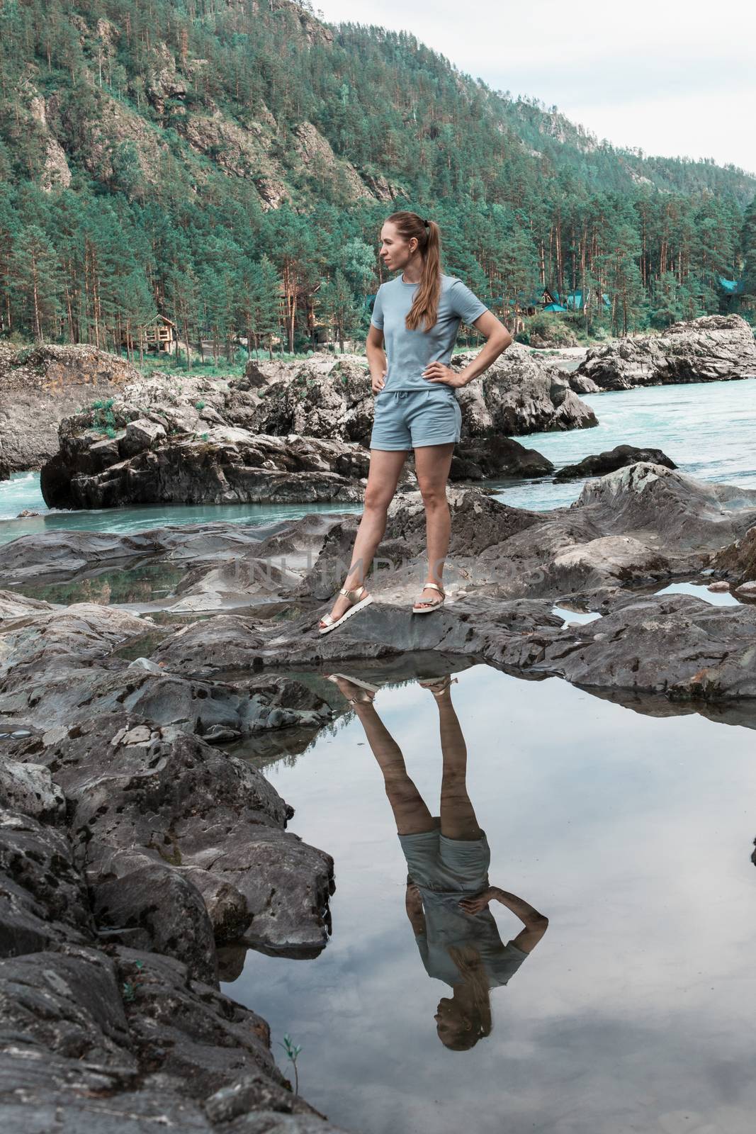 Woman at river in Altai Mountains territory