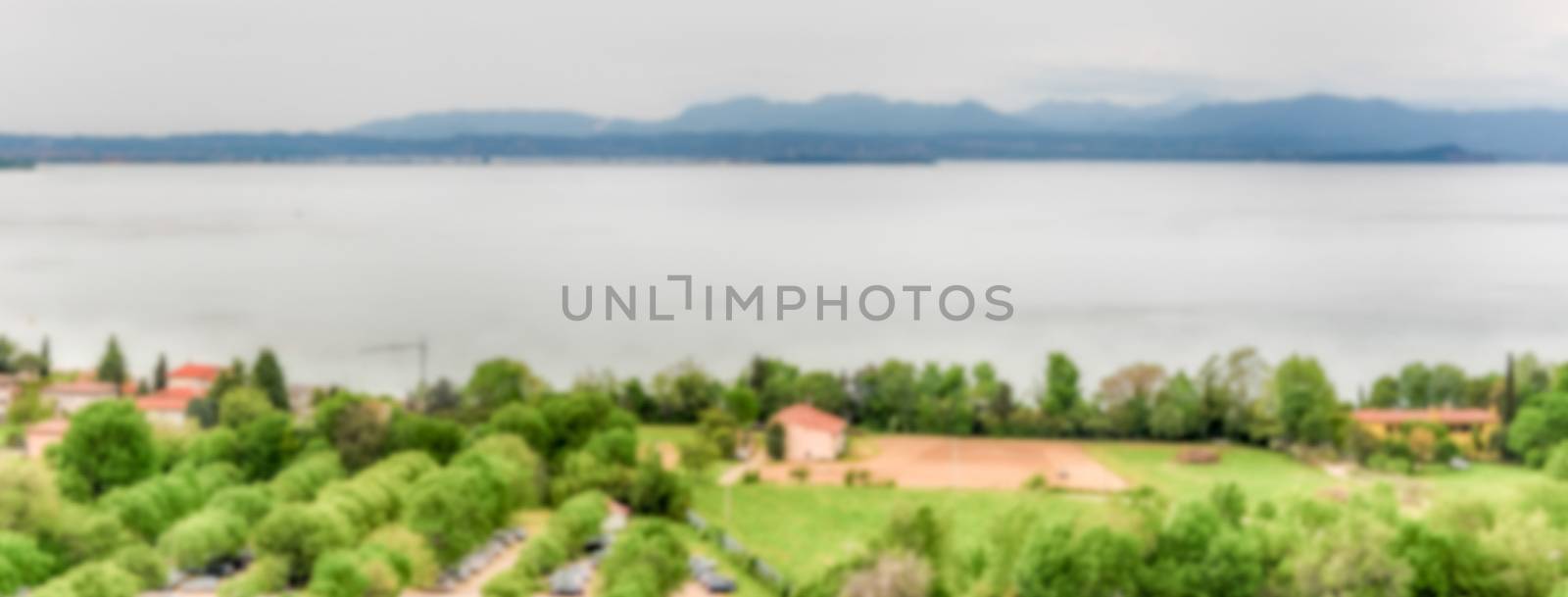 Defocused background with aerial view of Lake Garda, Italy. Intentionally blurred post production for bokeh effect
