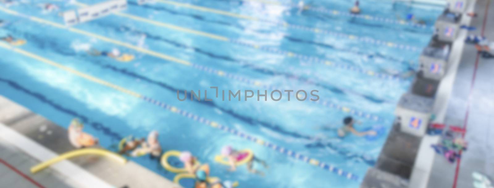 Defocused background with aerial view of a swimming pool indoor by marcorubino