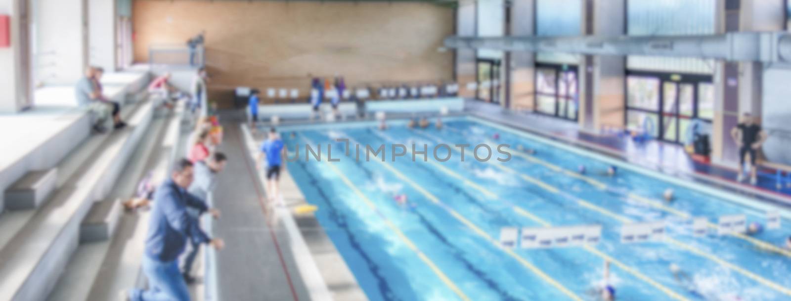Defocused background with aerial view of a swimming pool indoor. Intentionally blurred post production for bokeh effect