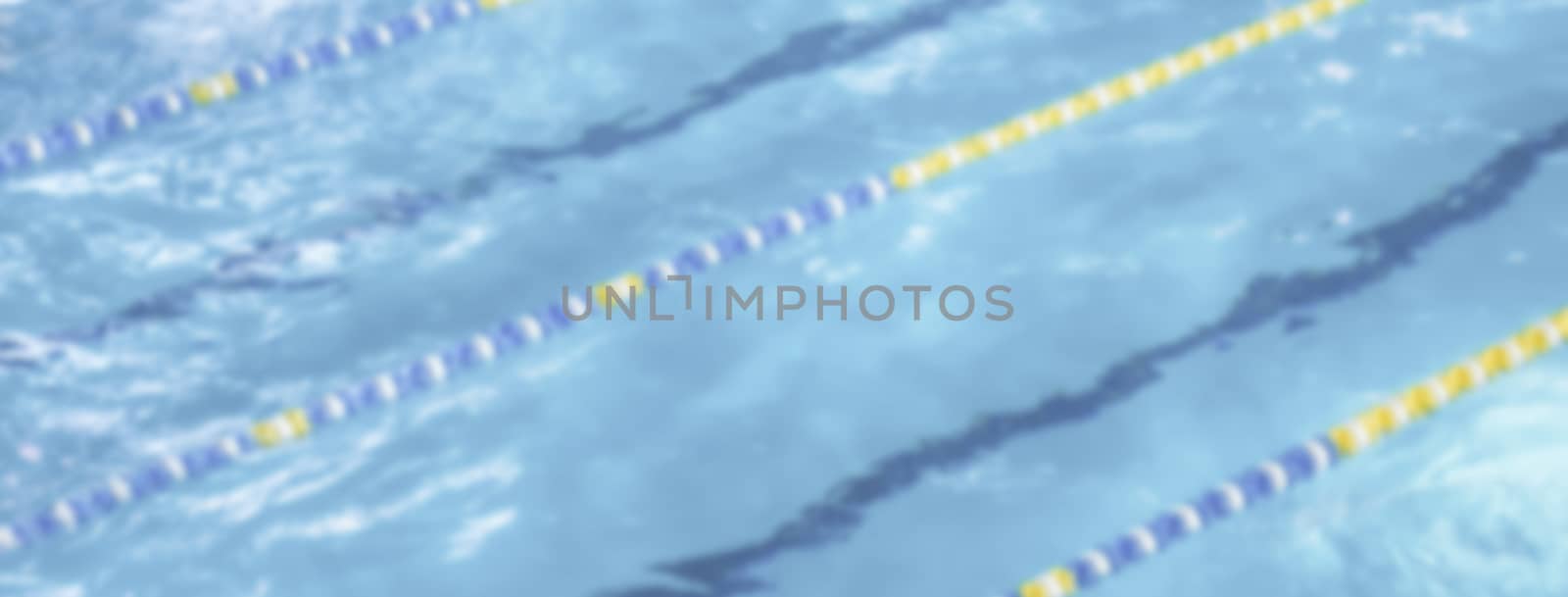 Defocused background with aerial view of a swimming pool with dividers. Intentionally blurred post production for bokeh effect