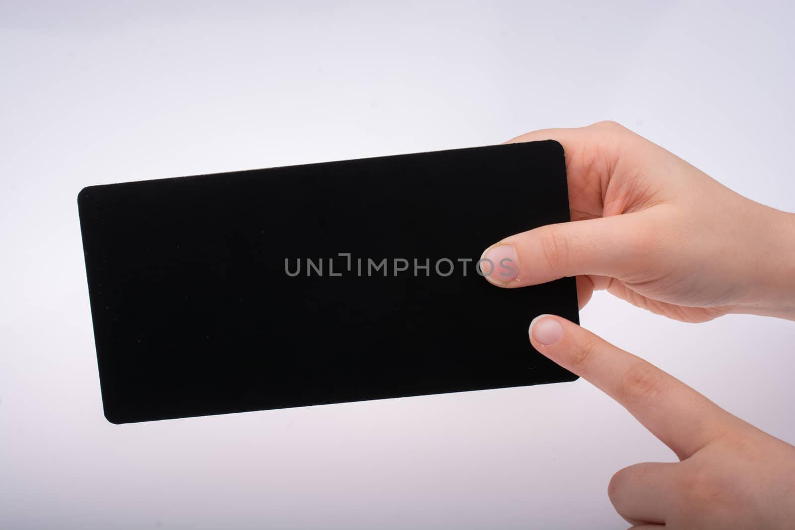 Rectangular shaped black notice board in hand on white background