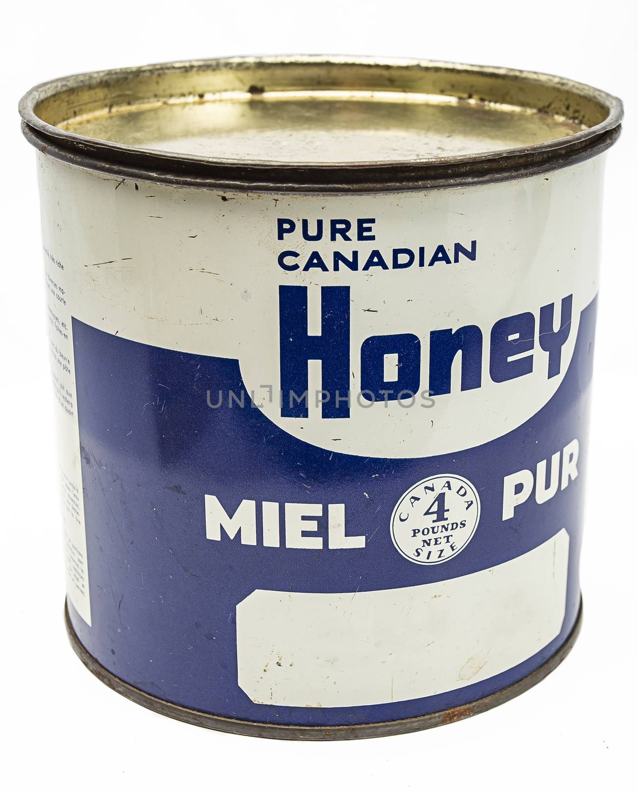 Vintage metal box of honey against white background