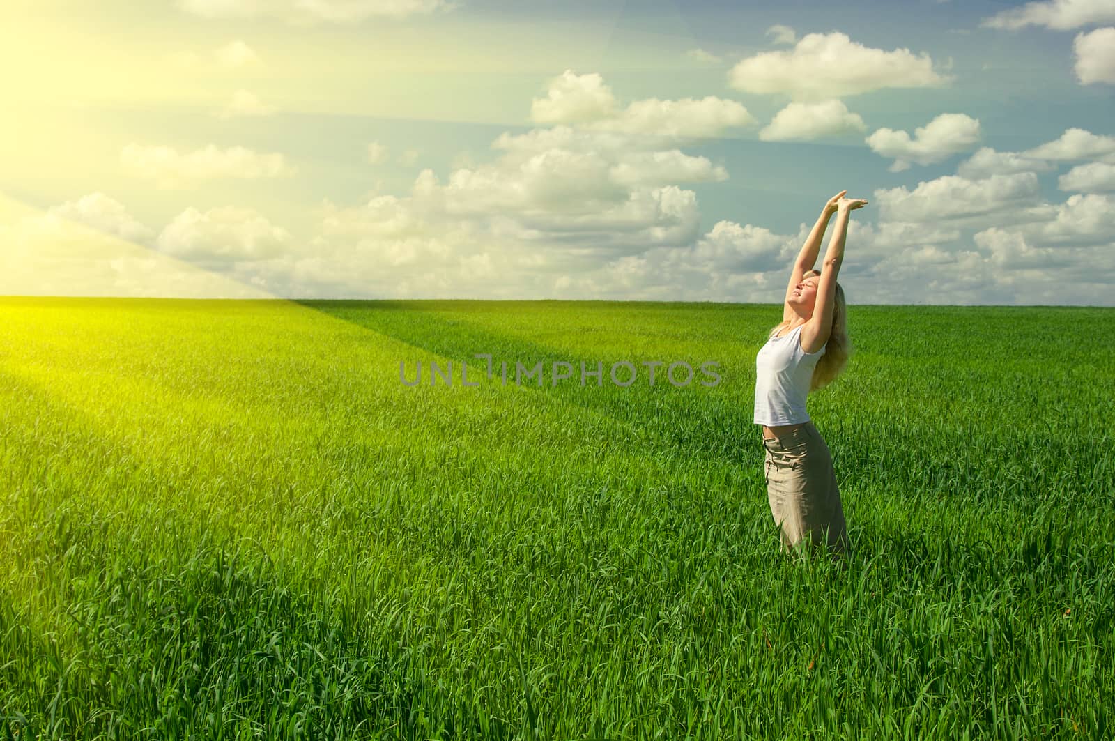 Beautiful spring young woman outdoors on medow under sun