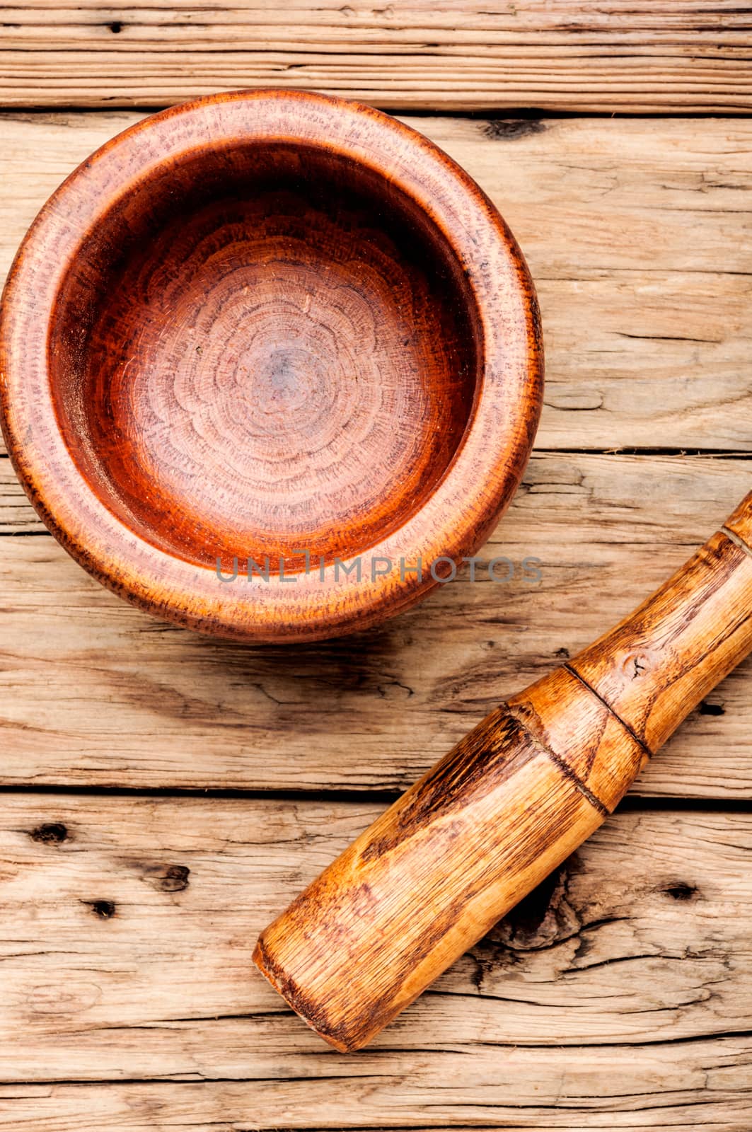 Empty wooden mortar and pestle on wooden old background