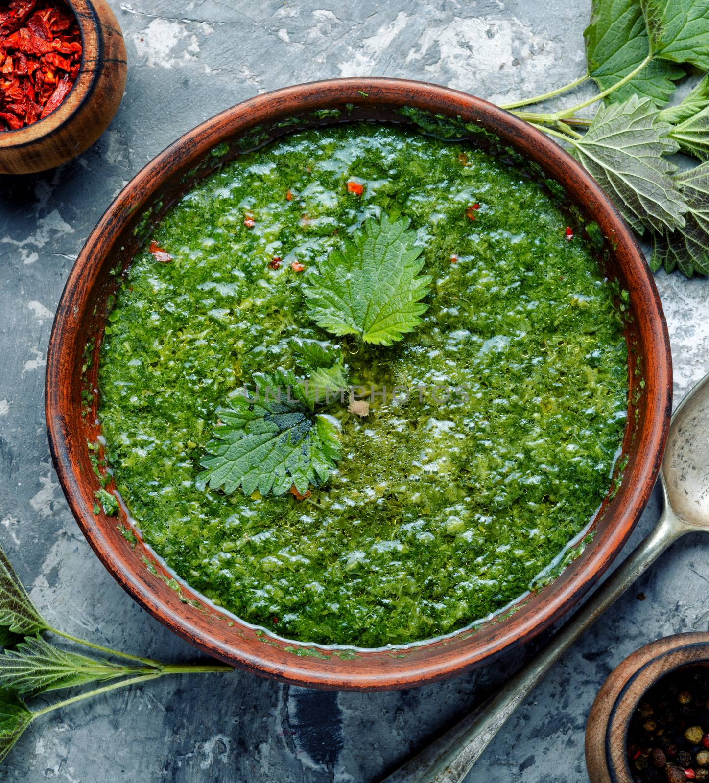 Nettle soup in bowl on wooden surface.Green nettle soup