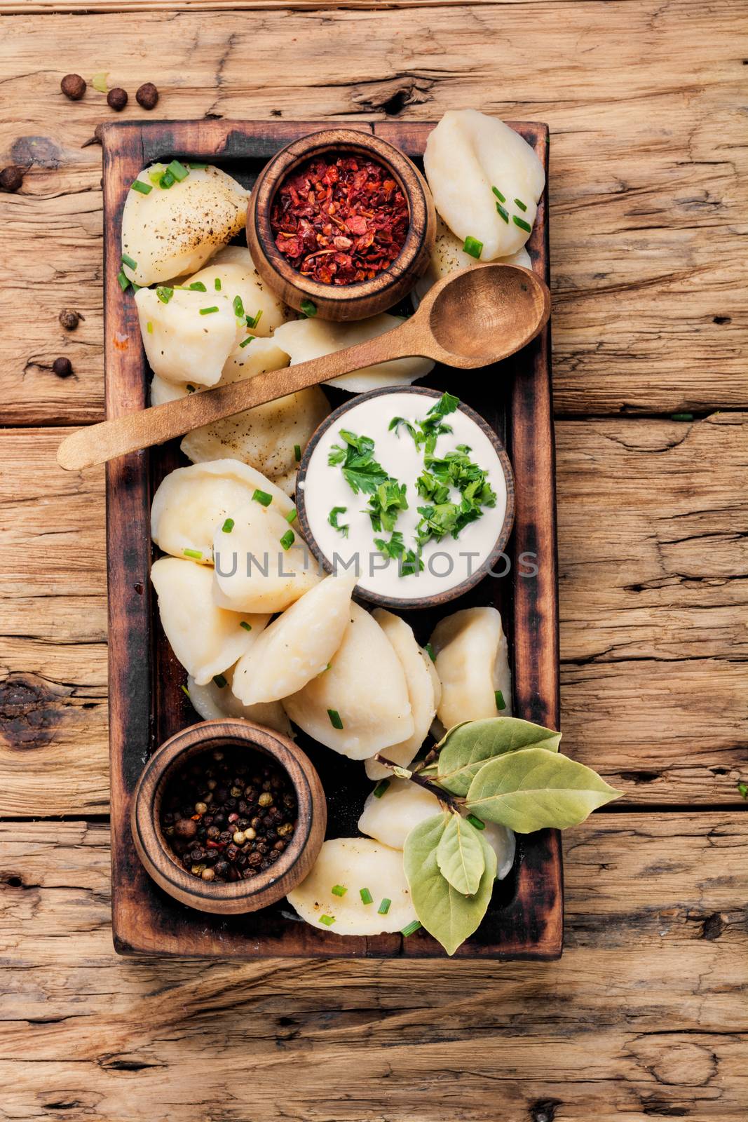 Russian food vareniki with potatoes on woodentable.Ukrainian cuisine