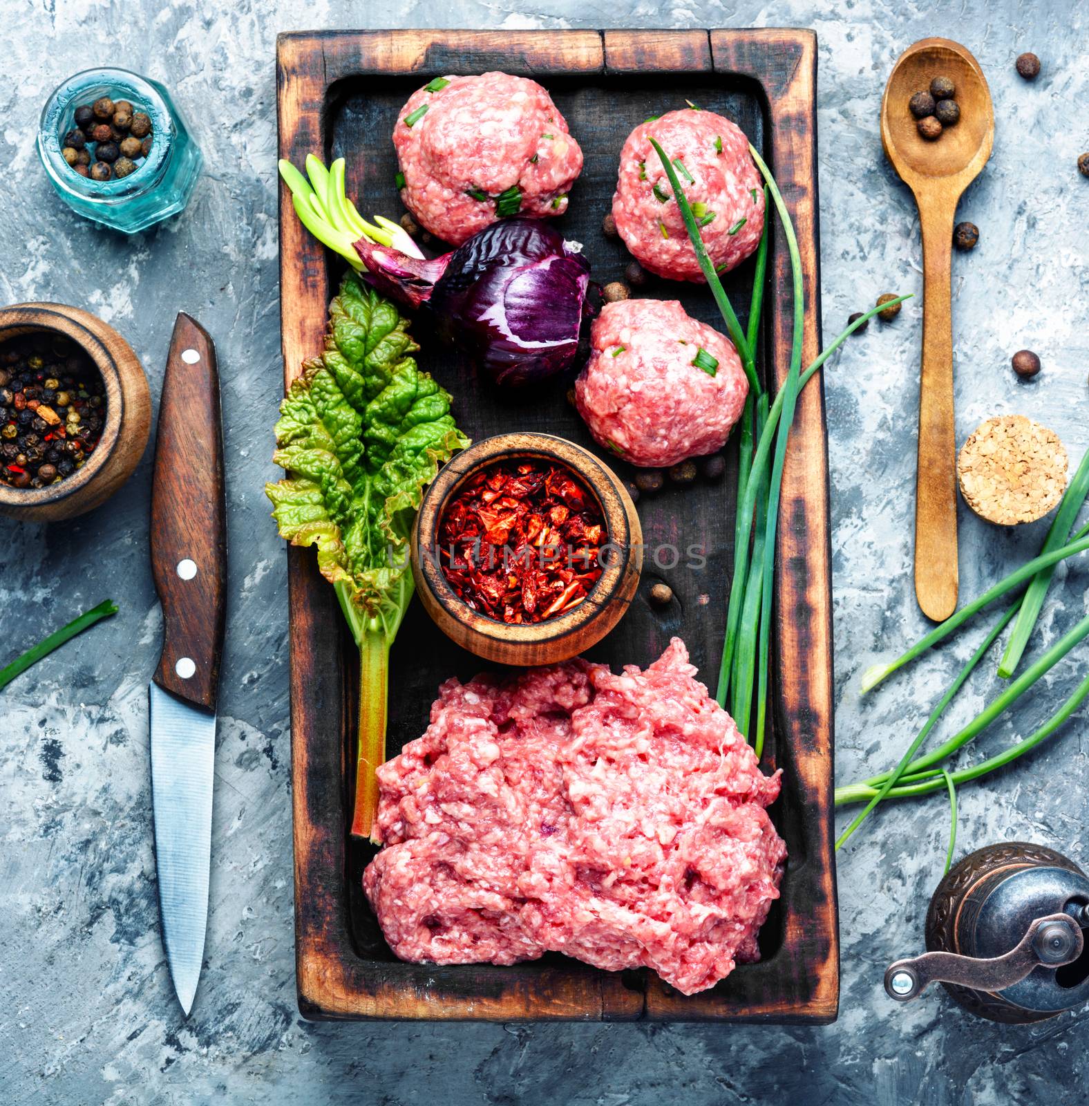 Fresh raw minced beef on cutting board and ingredients