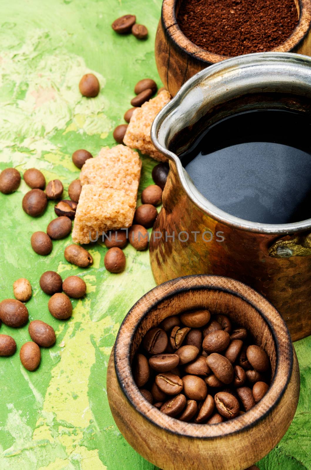 Roasted coffee beans and ground coffee.Coffee on green background