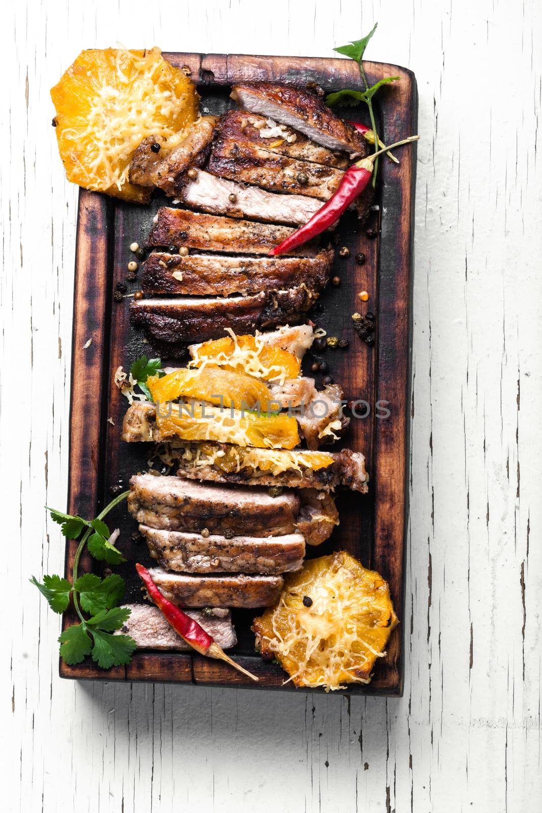 Juicy beef steak slices on wooden board