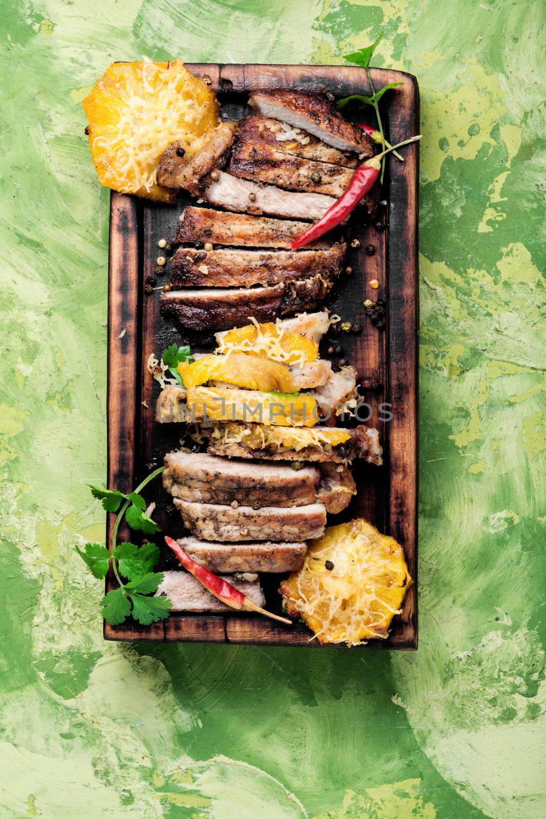 Grilled beef steak with pineapple on cutting board