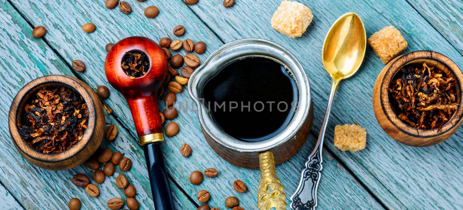 Stylish tobacco pipe with tobacco and brewed coffee