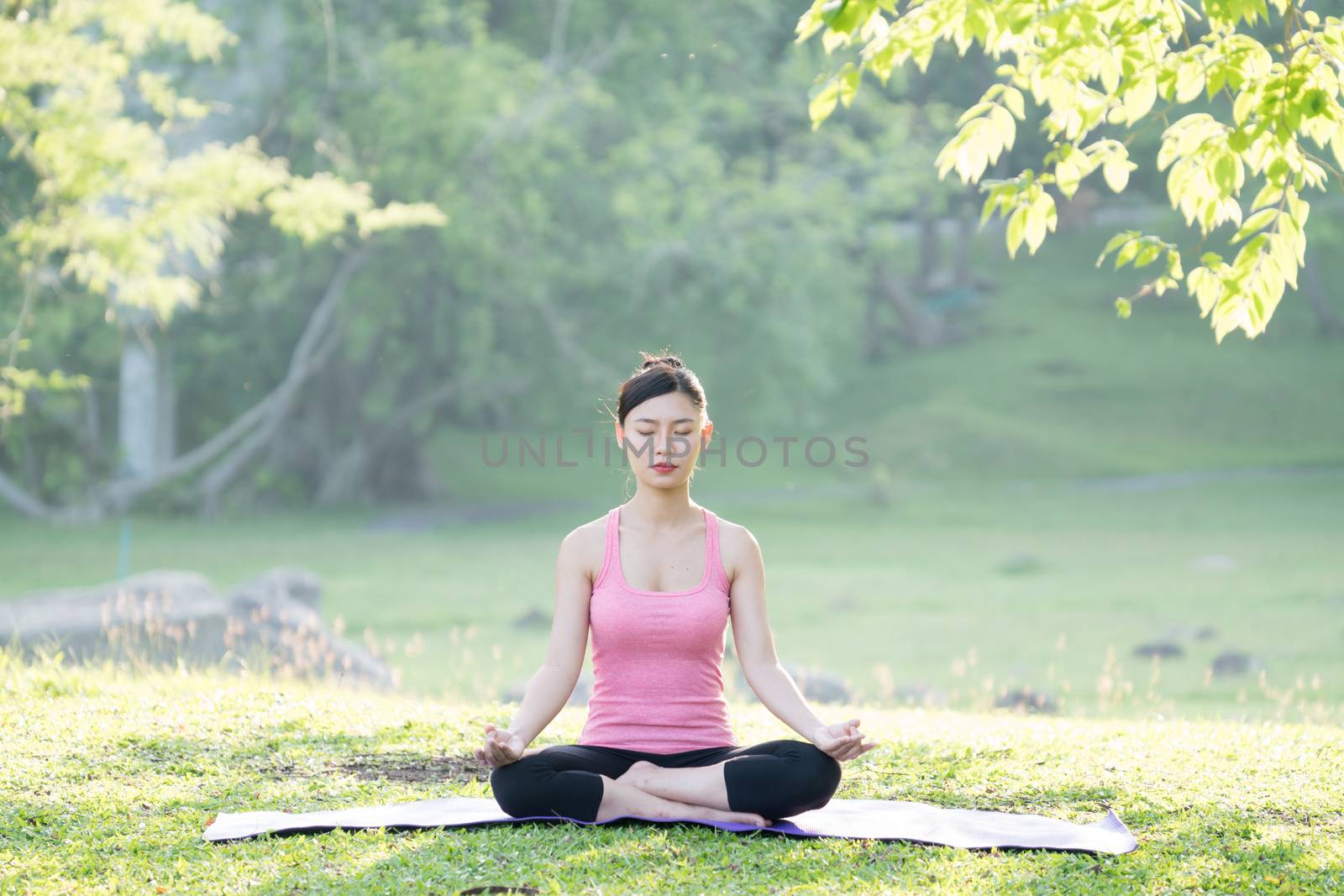 young beautiful asian woman practicing yoga  by anankkml