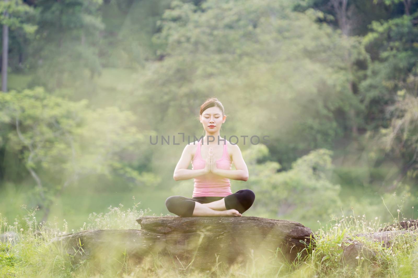 young beautiful asian woman practicing yoga  by anankkml