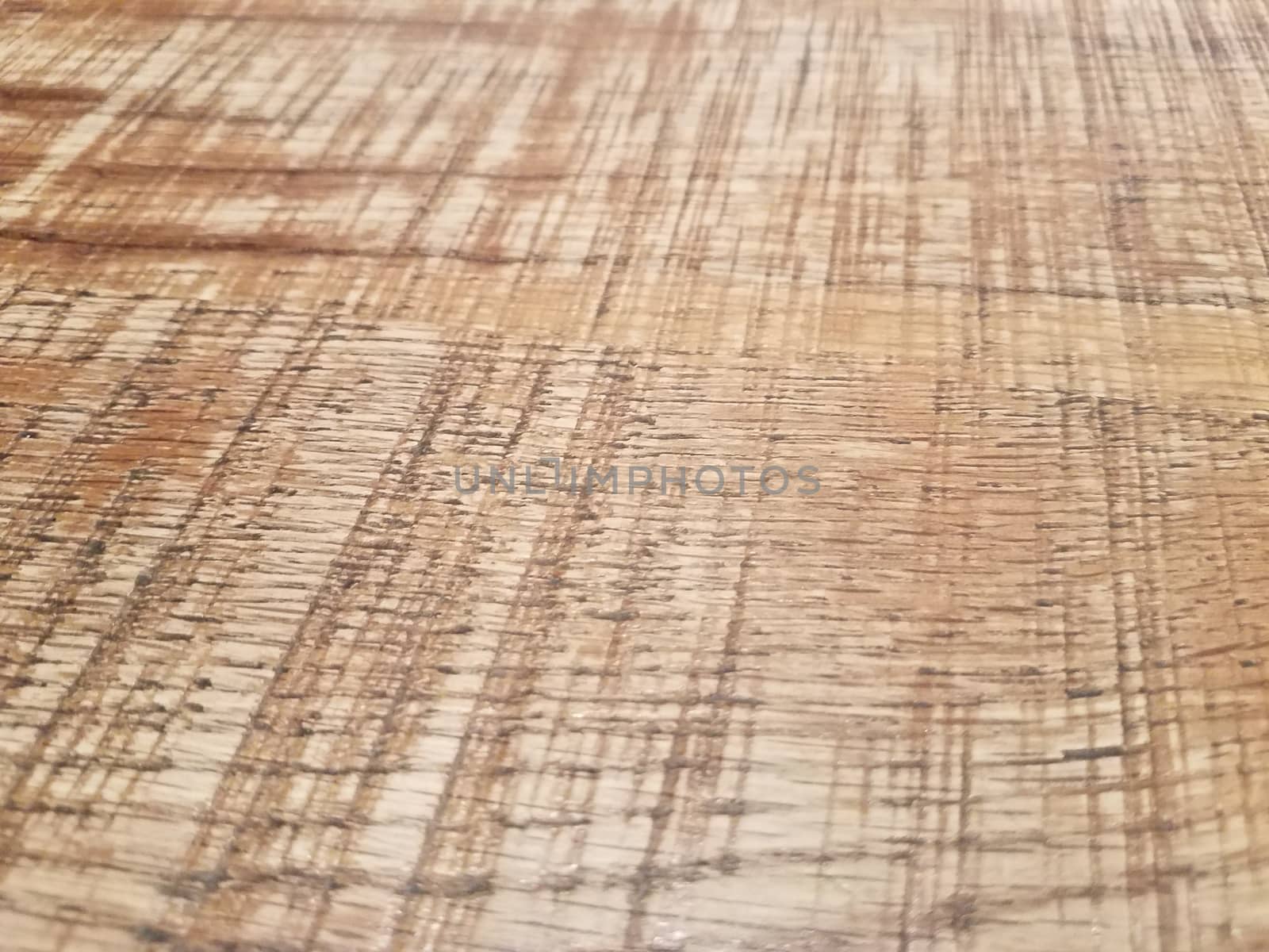 worn or weathered brown wood table or surface up close
