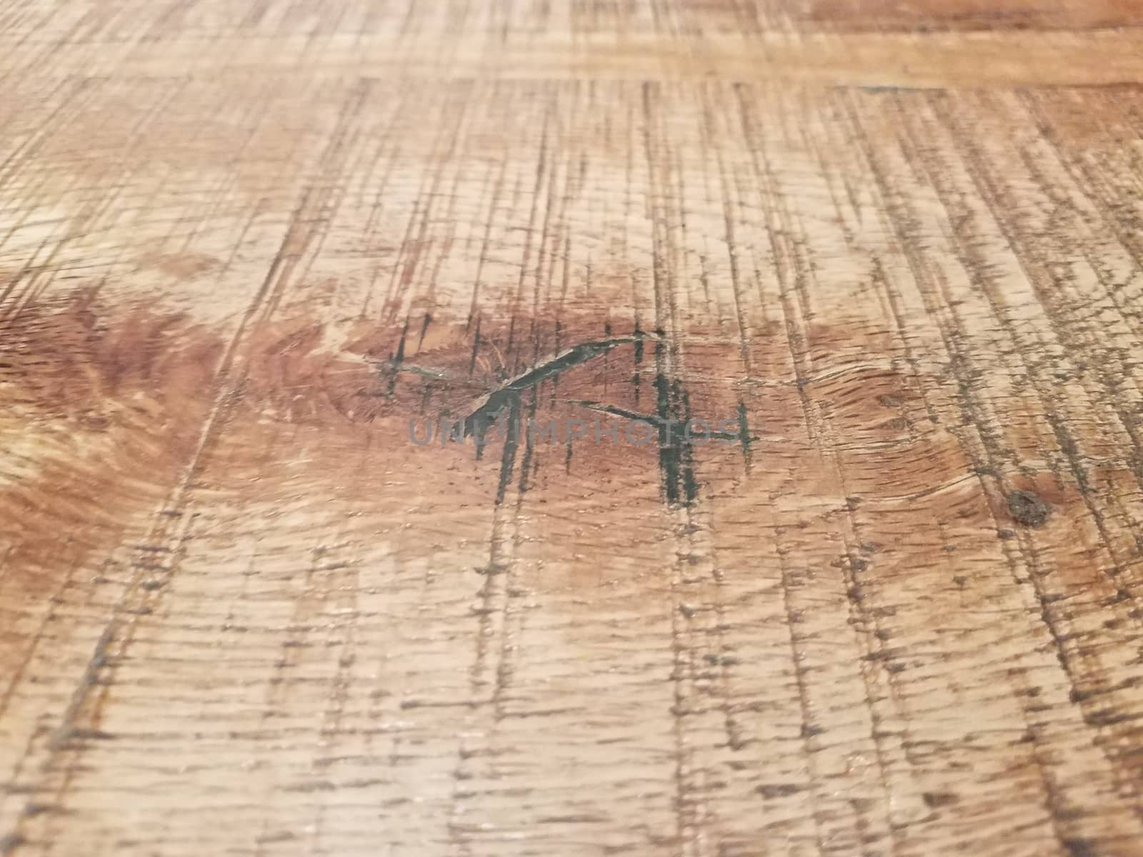 worn or weathered brown wood table or surface up close