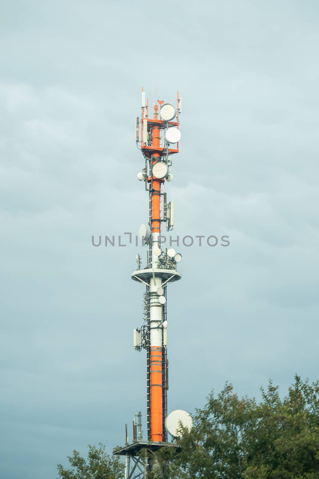 A huge radio tower with sky and clouds in the background