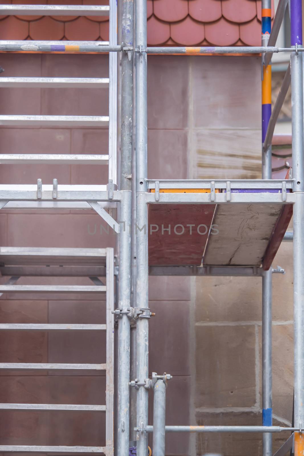 A scaffolding on a house, construction site by sandra_fotodesign