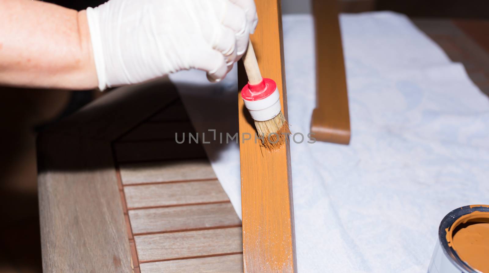 Woman strokes a wooden table with fresh paint