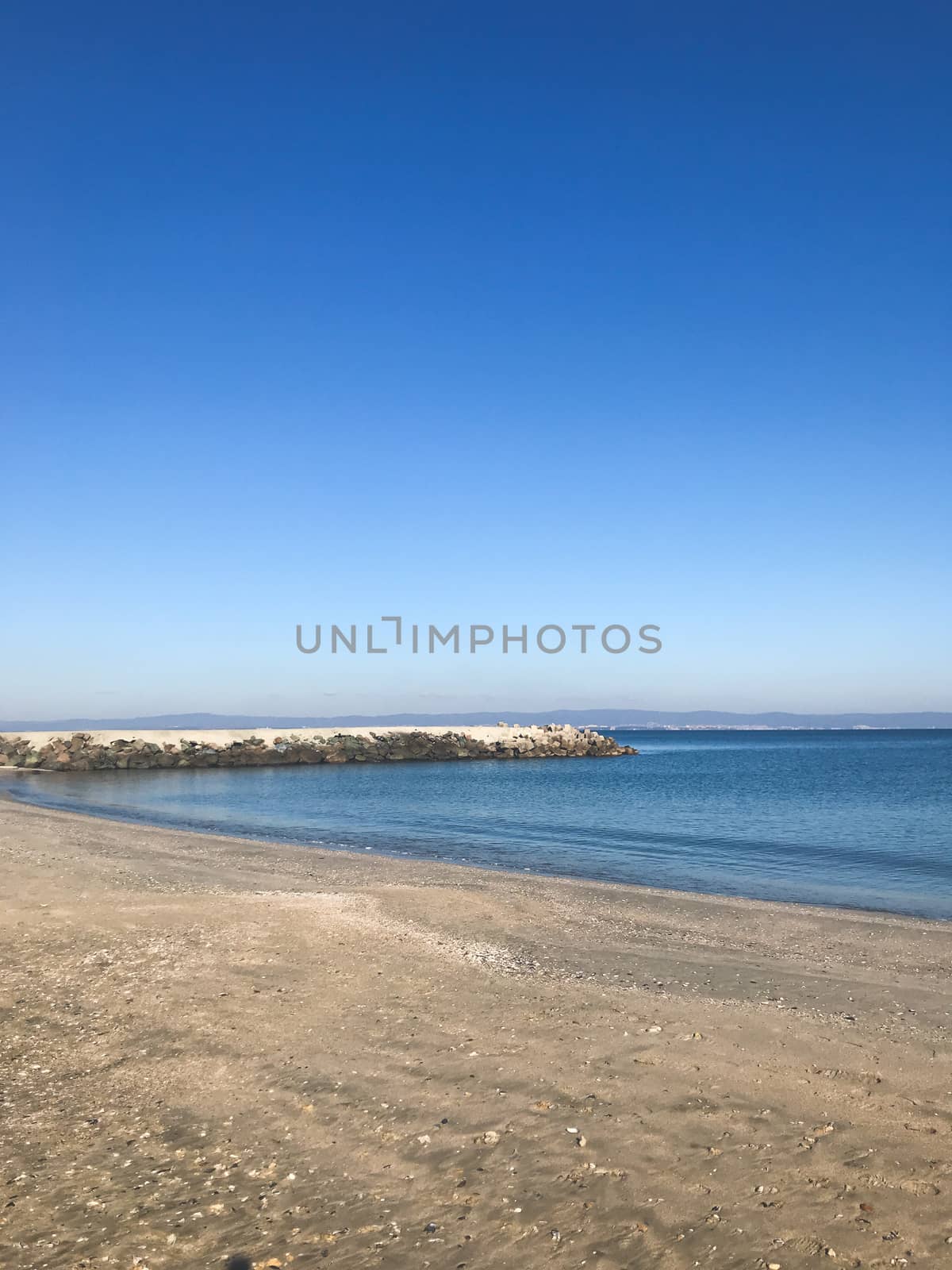 Scenic View Of Sea Against Clear Blue Sky and Sunlight