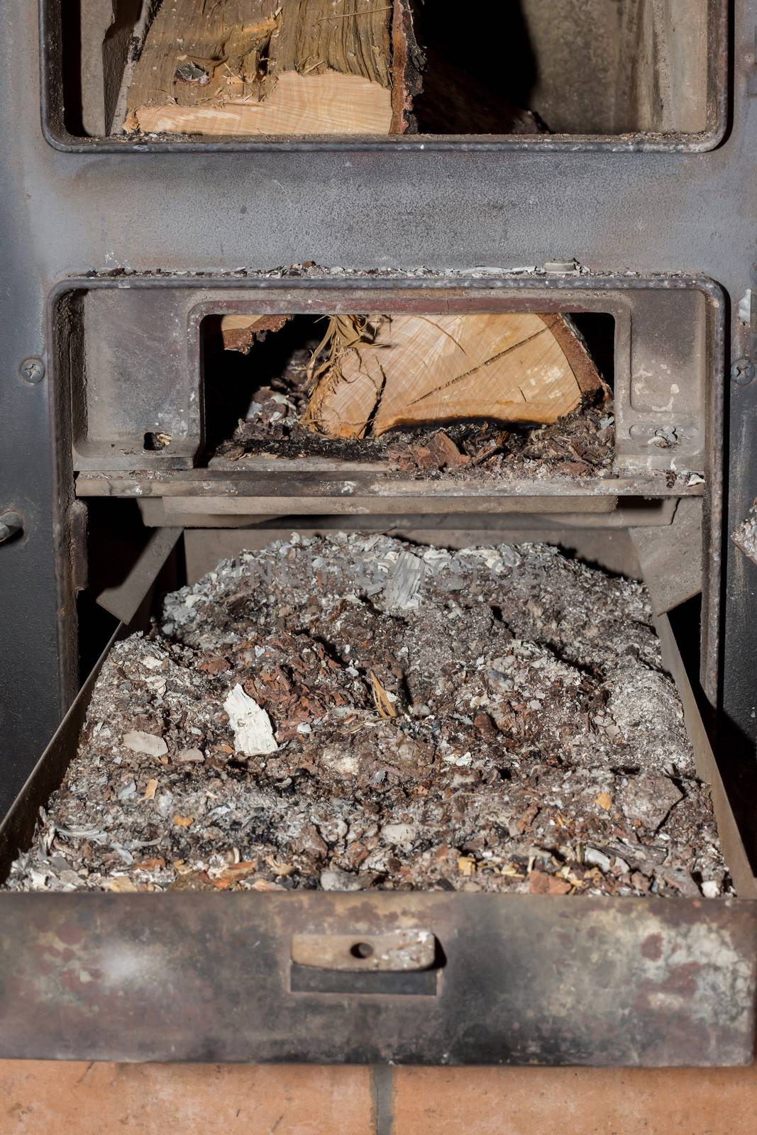 A box full of ashes under the fireplace by sandra_fotodesign