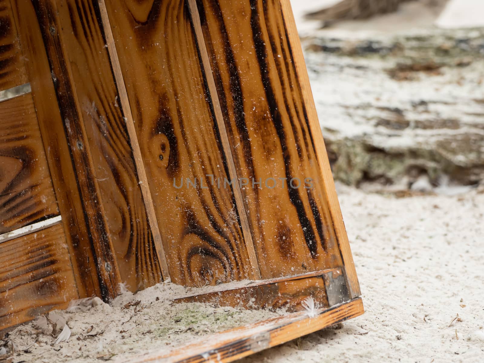 An old wooden box lies in the sand