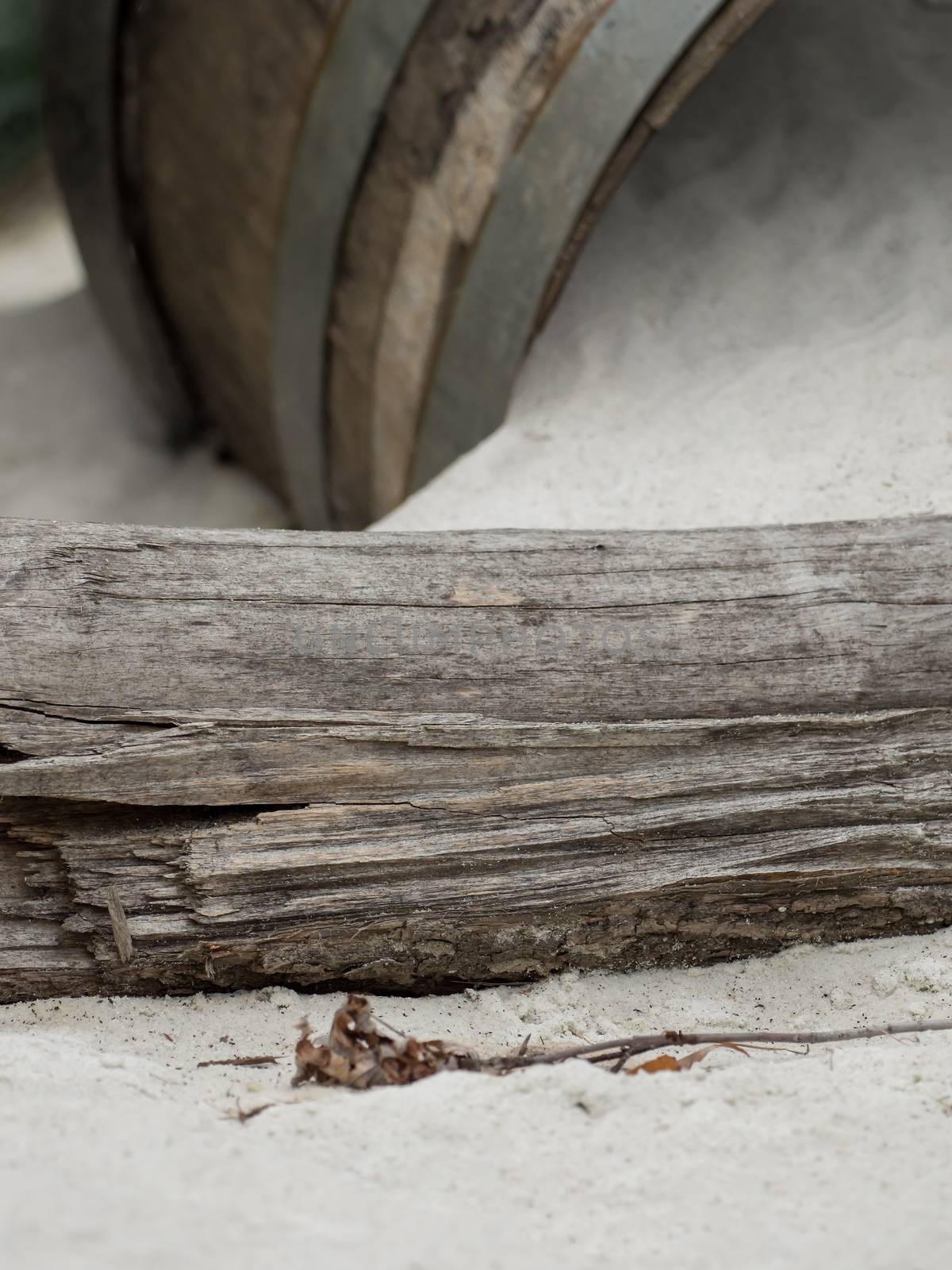 An old wooden barrel lies in the sand by sandra_fotodesign