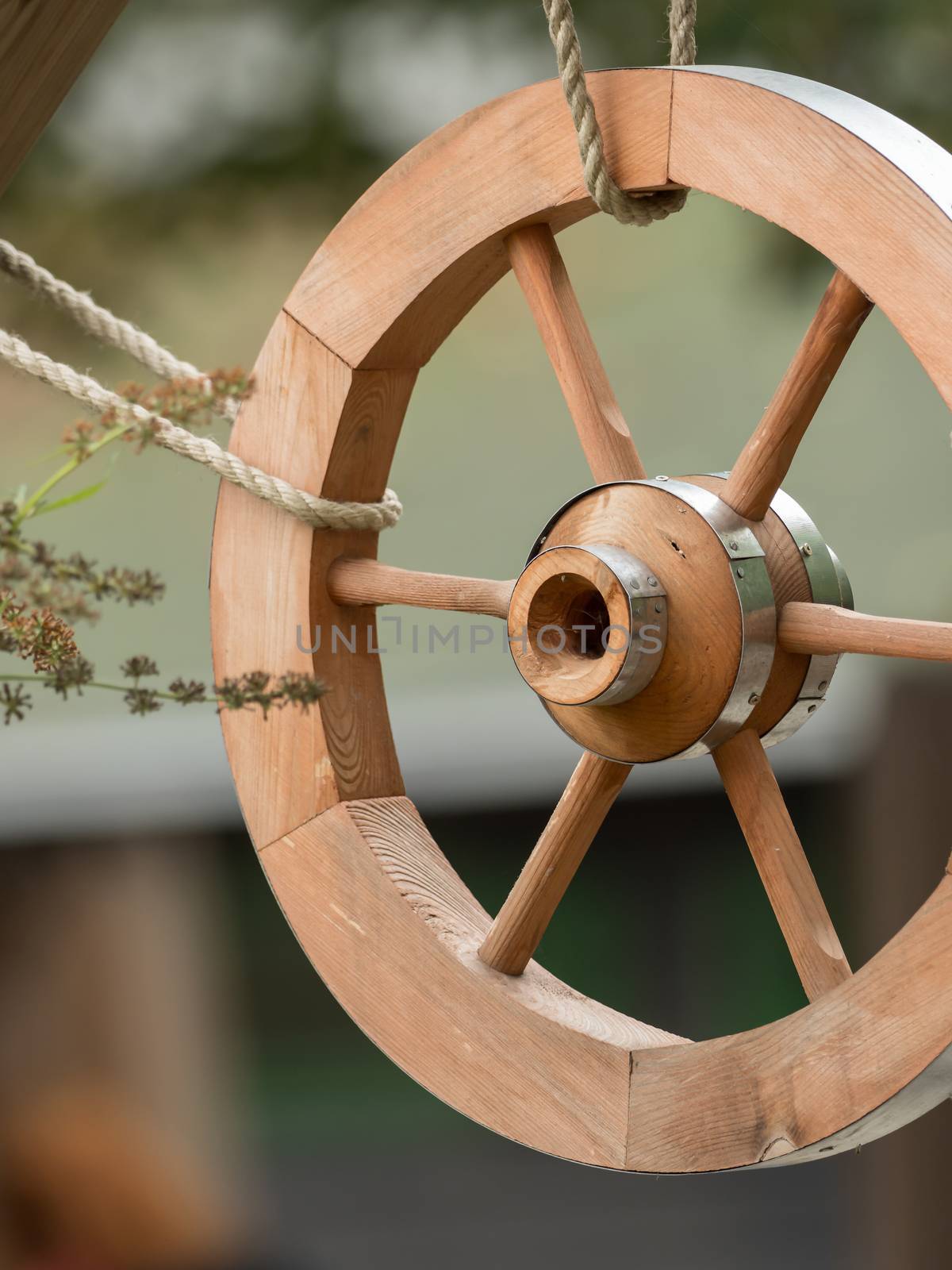 A wooden wheel hangs out as a decoration