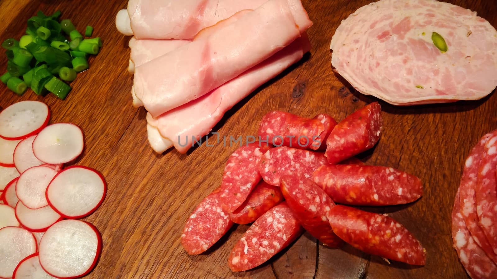 Various sausages on a wooden plate by sandra_fotodesign
