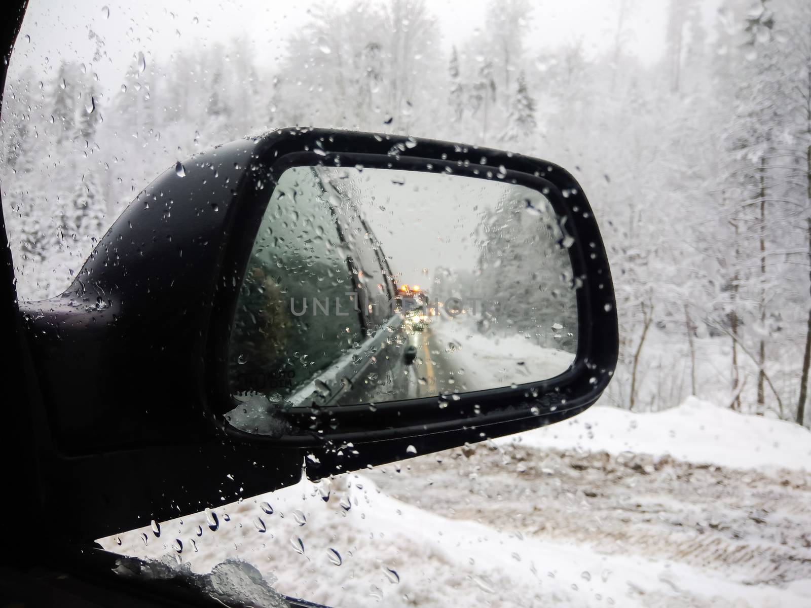 An exterior mirror of a car in winter