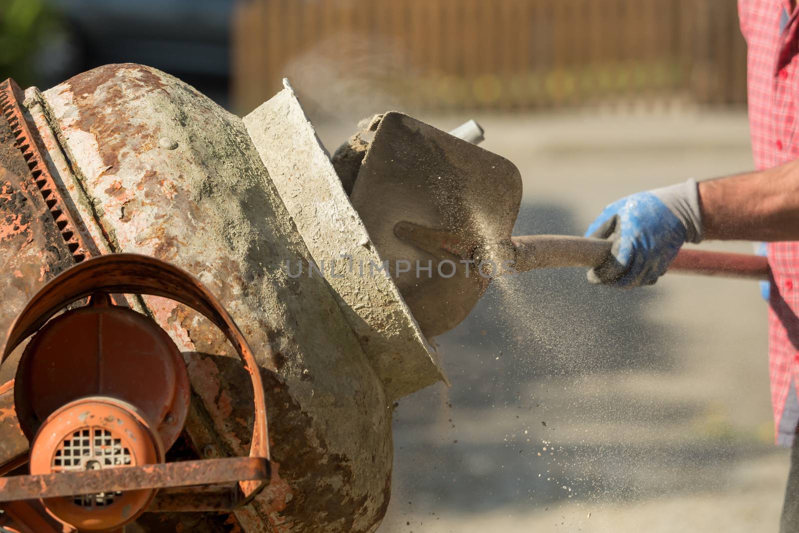 Construction site work with concrete mixer and wheelbarrows