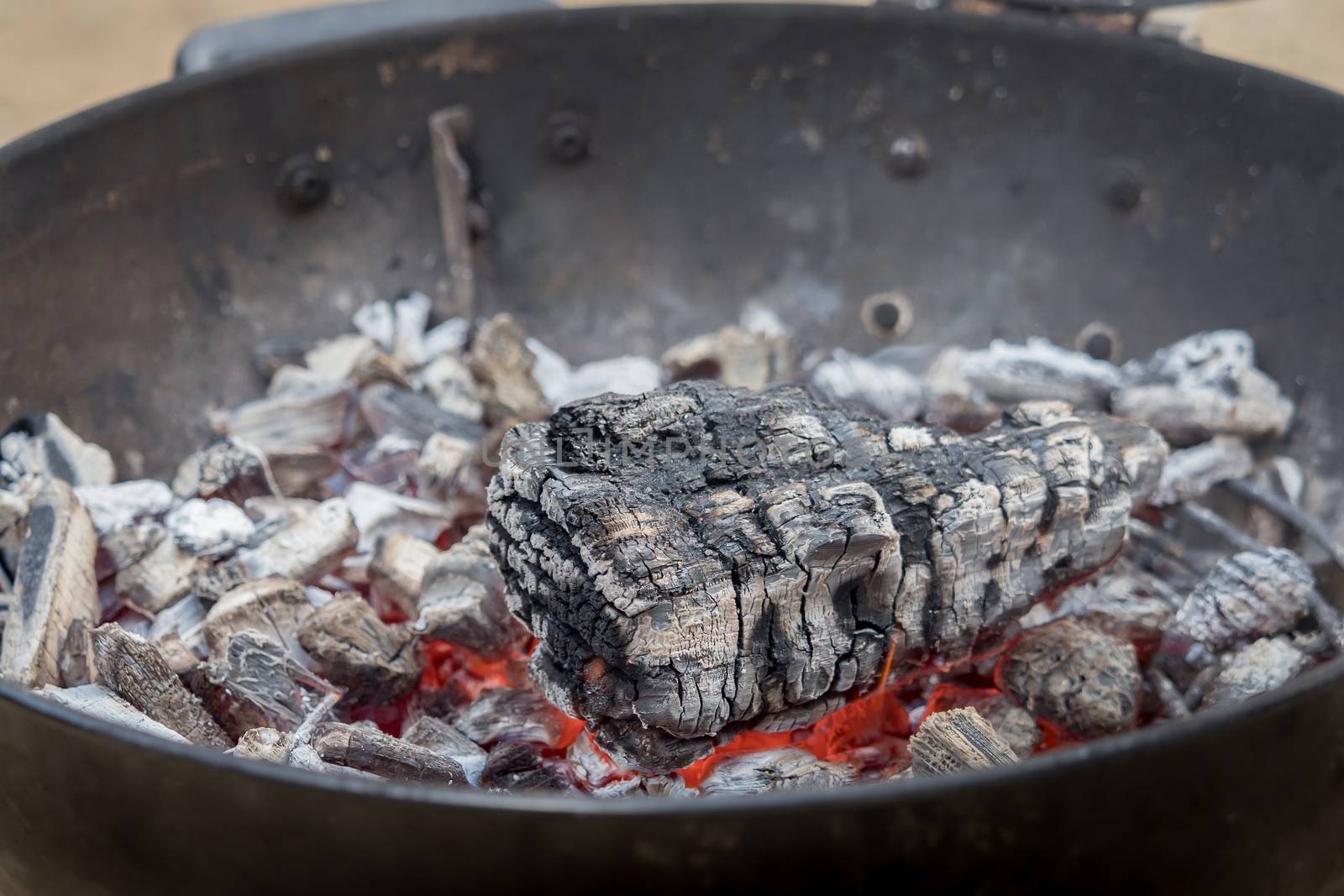 Hot charcoal burns in the grill with embers by sandra_fotodesign