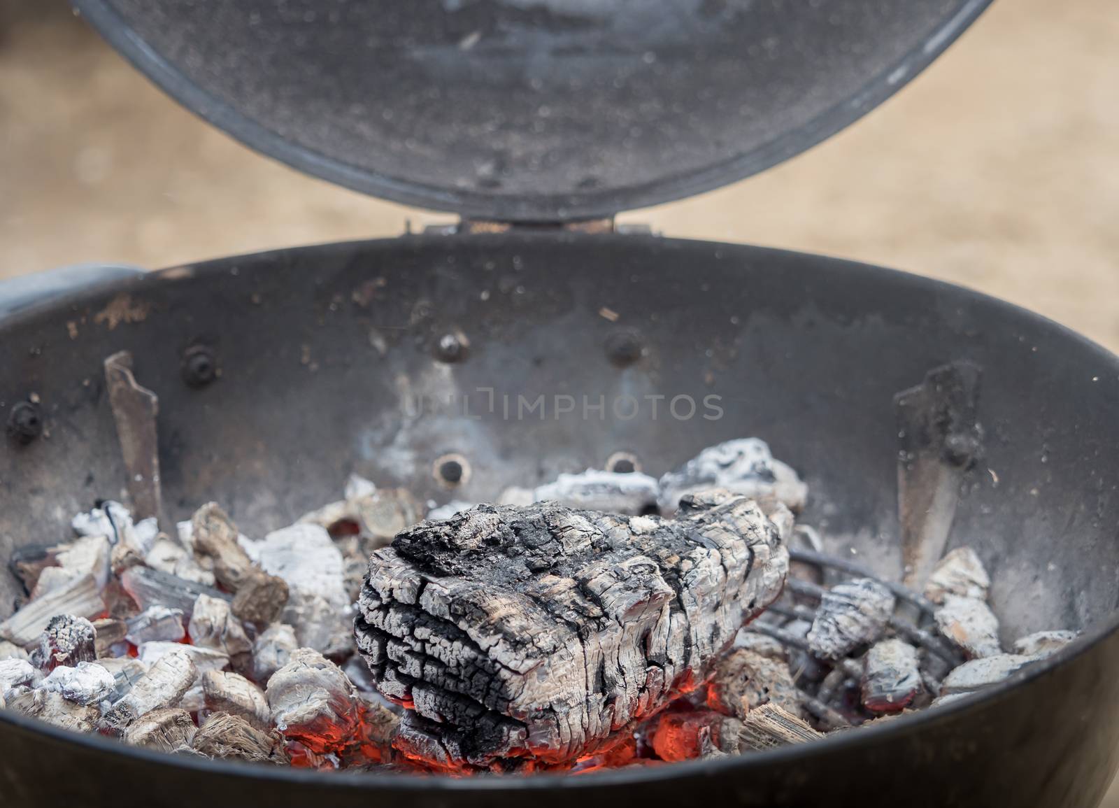 Hot charcoal burns in the grill with embers by sandra_fotodesign