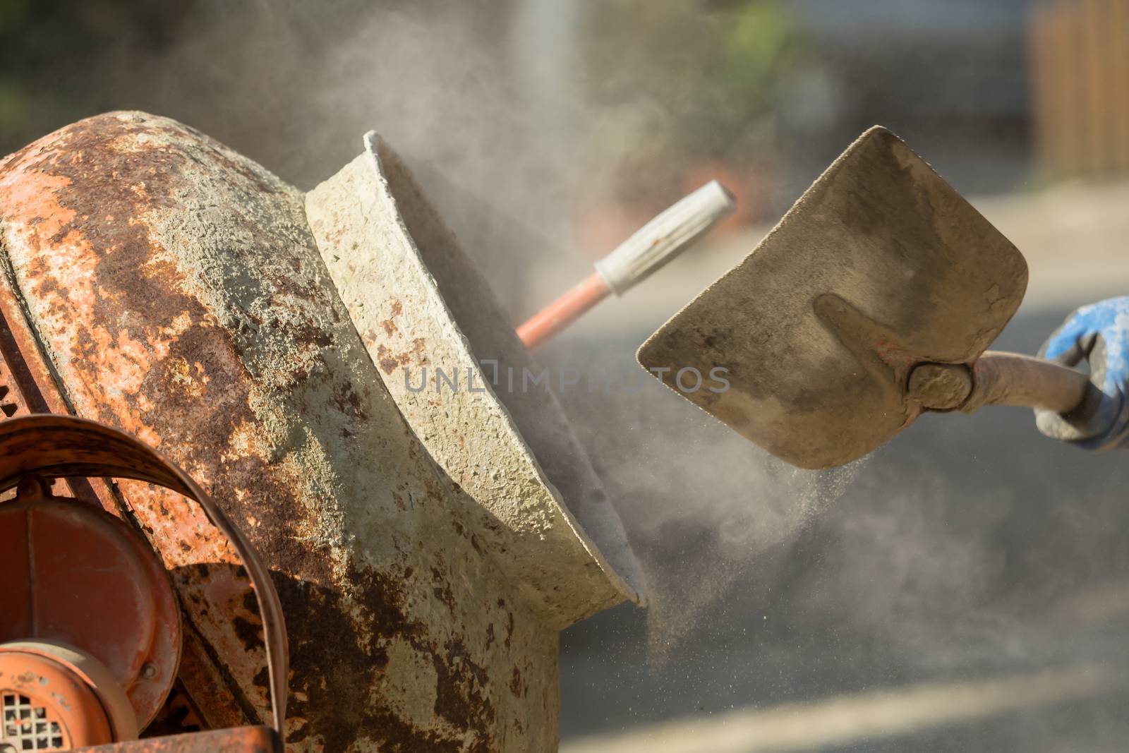 Construction site work with concrete mixer and wheelbarrows by sandra_fotodesign