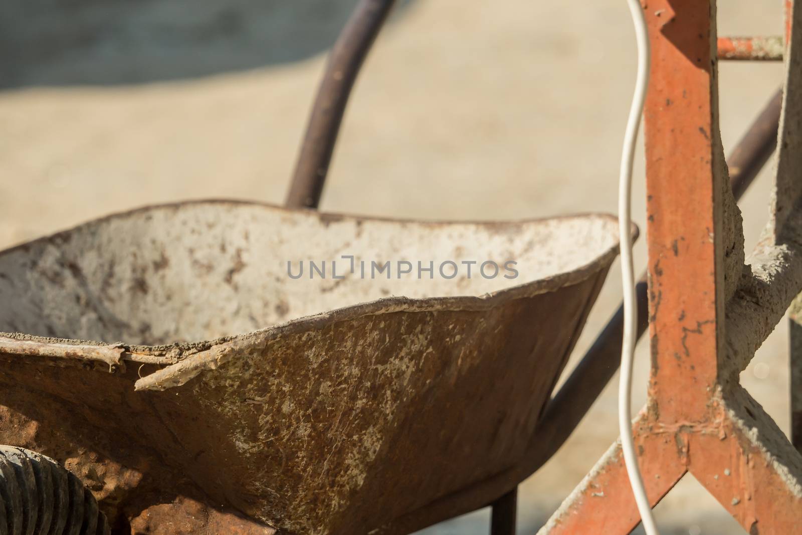 Construction site work with concrete mixer and wheelbarrows by sandra_fotodesign