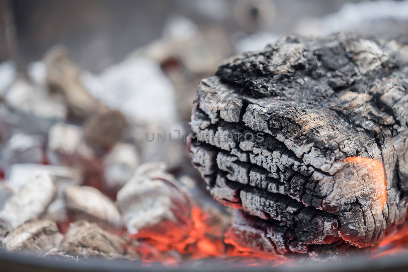 Hot charcoal burns in the grill with embers by sandra_fotodesign