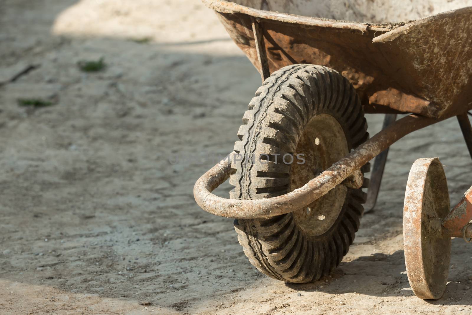 Construction site work with concrete mixer and wheelbarrows