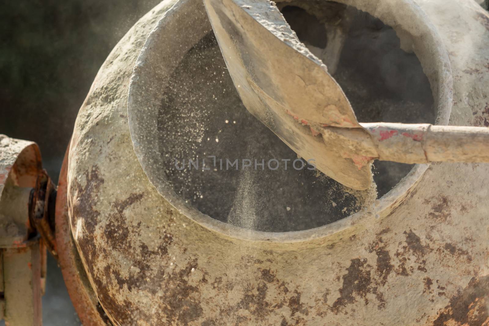 Construction site work with concrete mixer and wheelbarrows