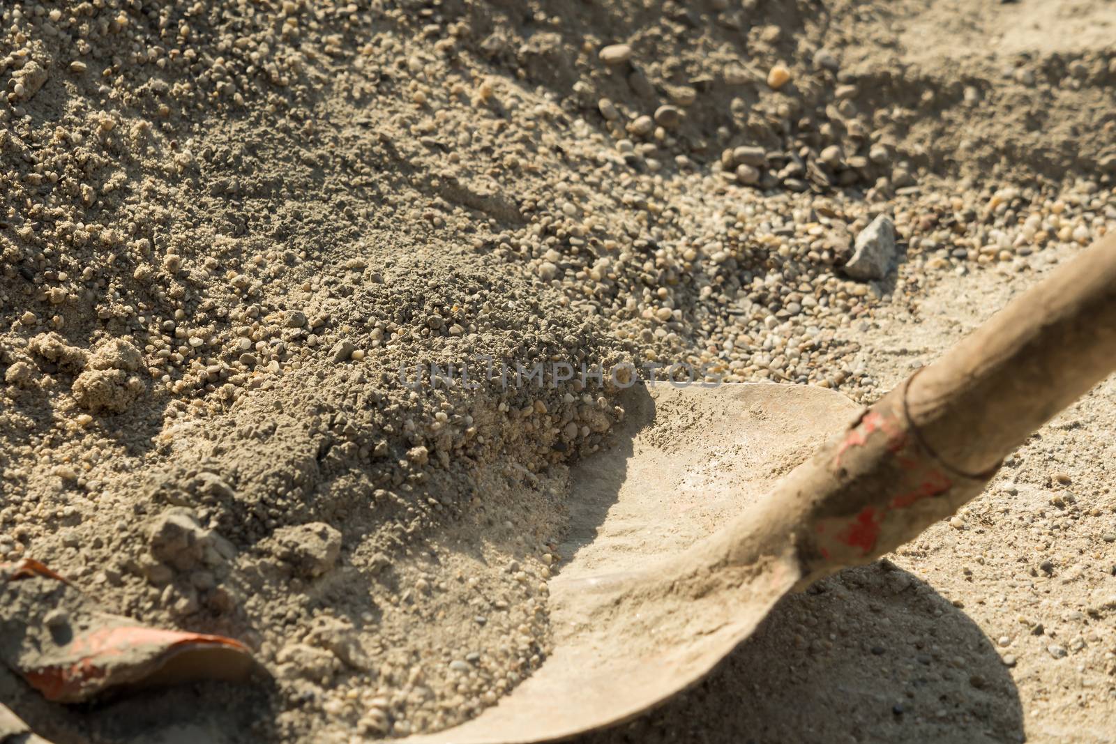 Construction site work with concrete mixer and wheelbarrows