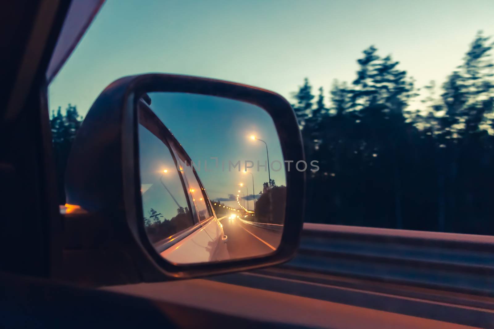 Night highway in the side mirror while driving - photo, image. Soft focus by galsand