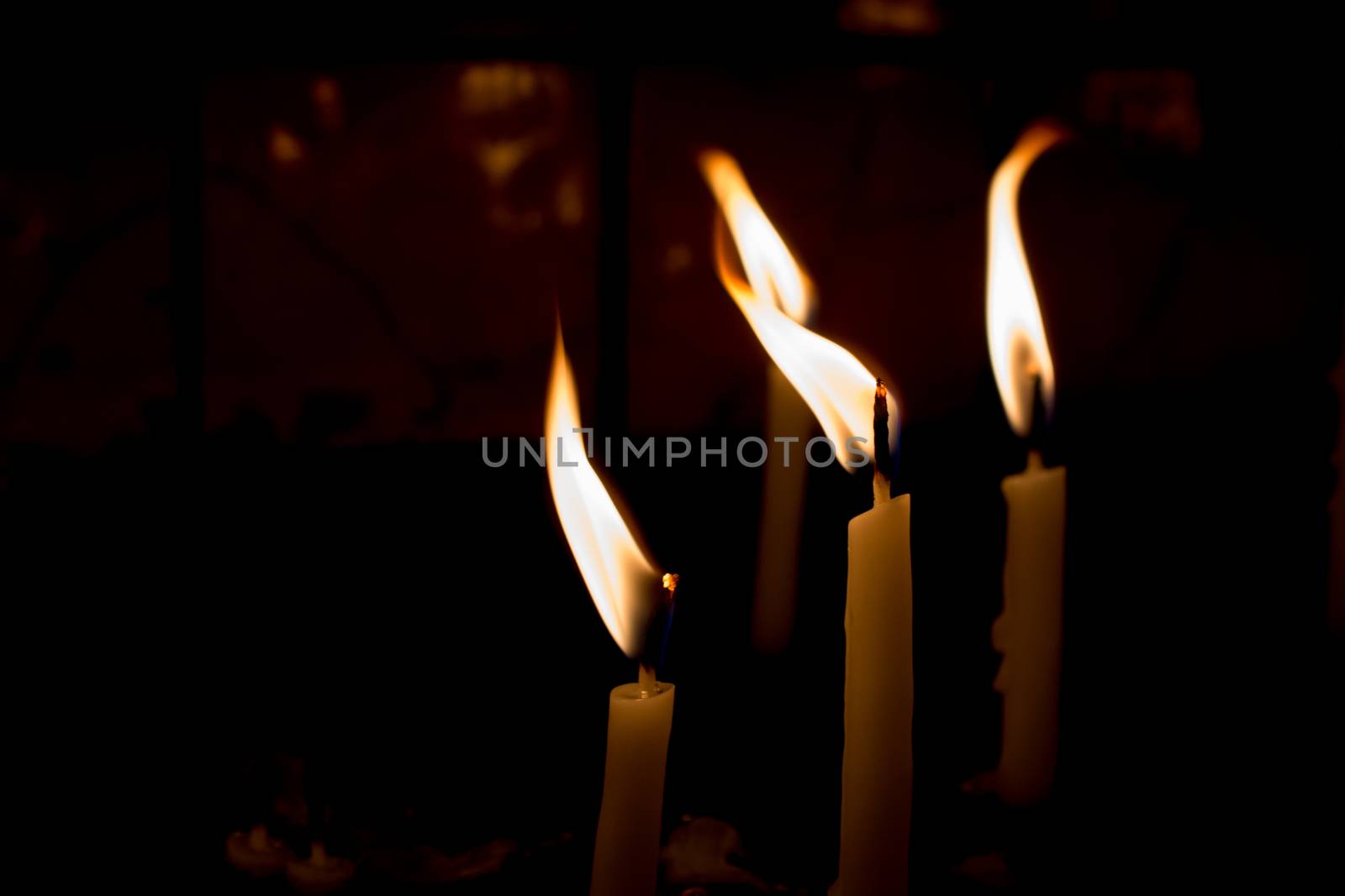 Burning candles give light in the dark by berkay