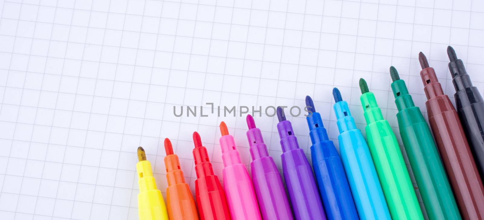 Felt-tip pens on a notebook by berkay