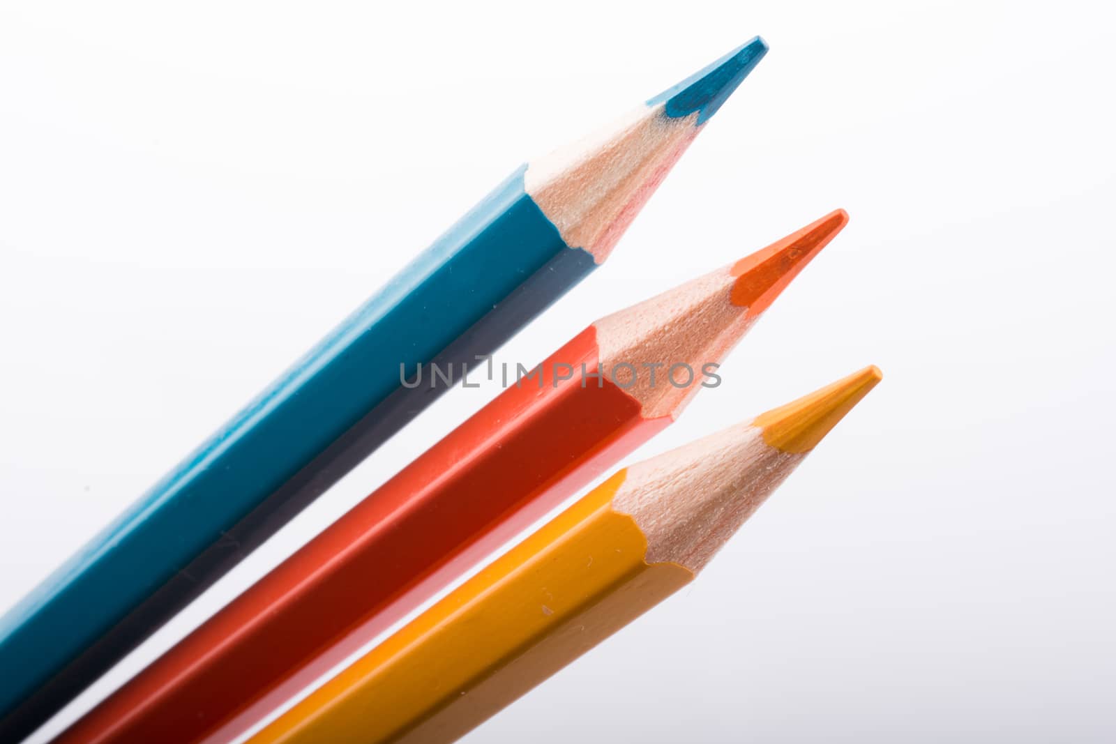 Three Color Pencils on a white background