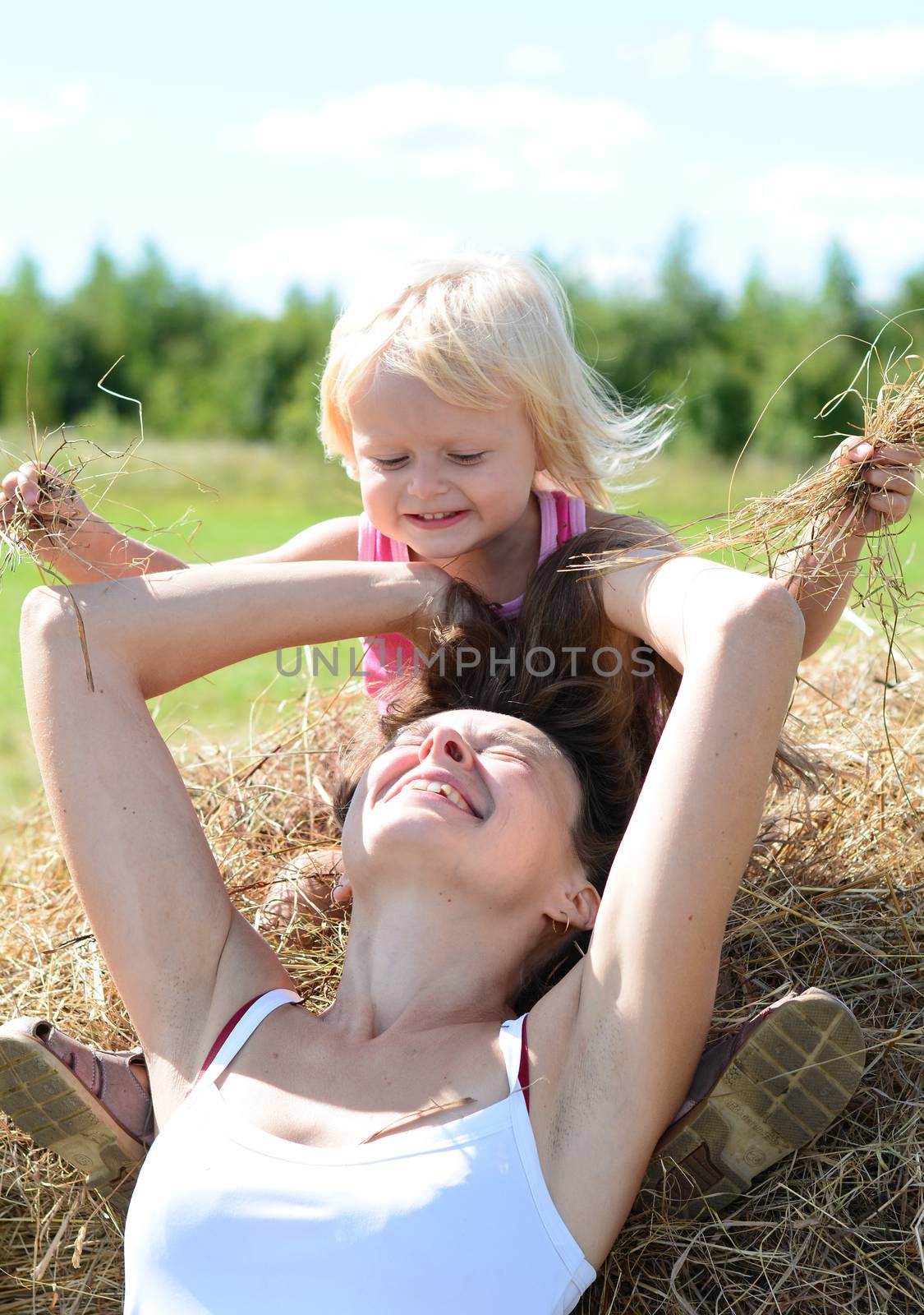 Portrait of  mother and child near haystack by jordano