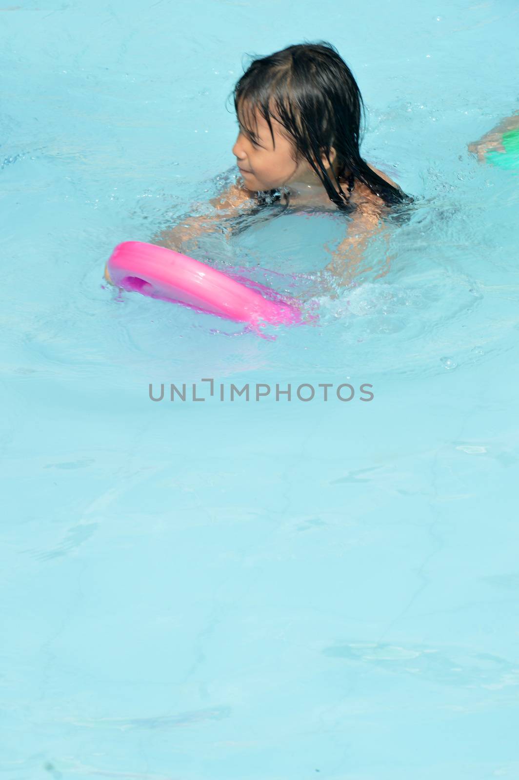 asian little girl playing in the pool by antonihalim