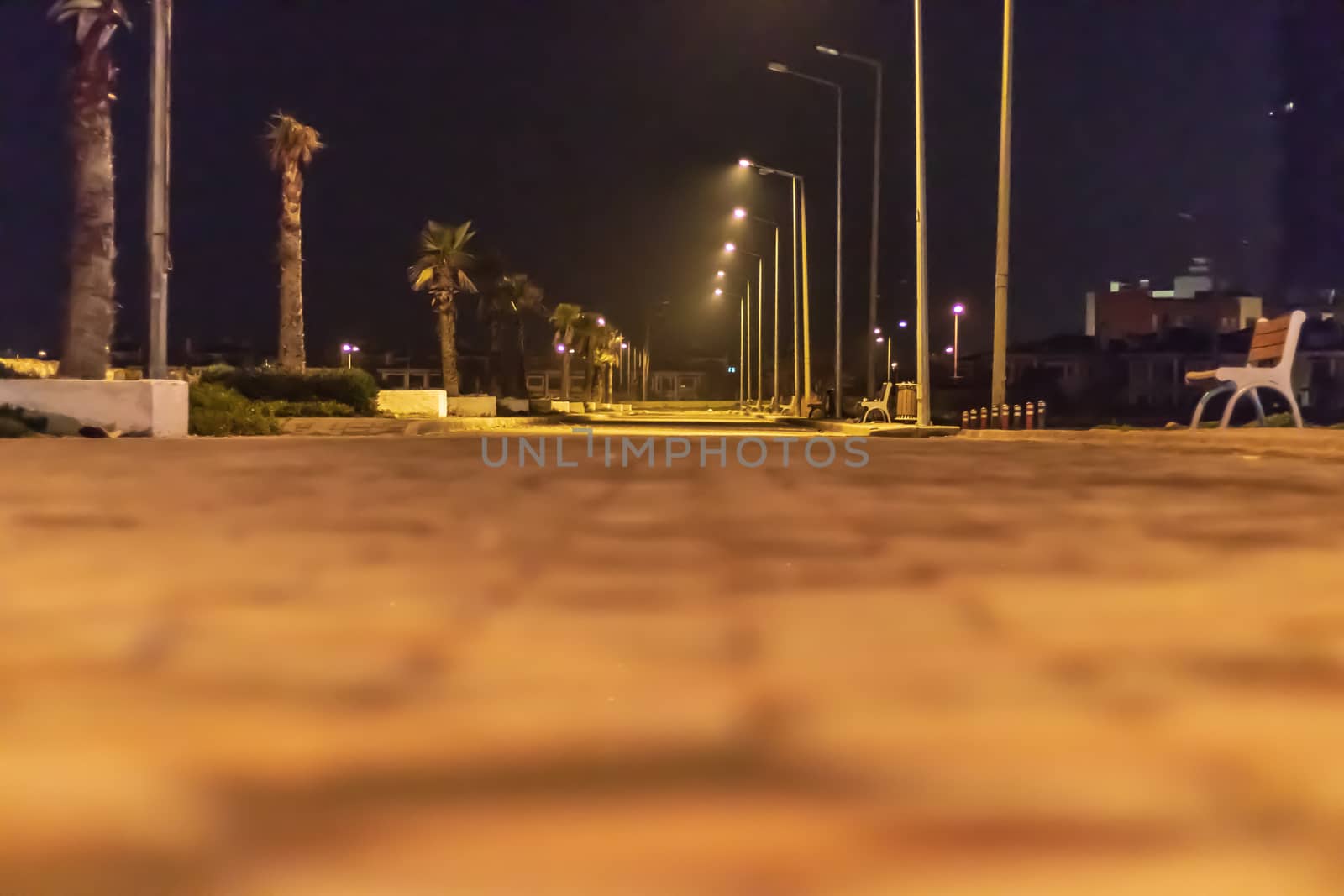 a crouching night shoot from coast road with city lights. photo has taken at izmir/turkey.